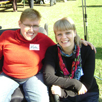 Girl in wheelchair with PACE volunteer/staff helper