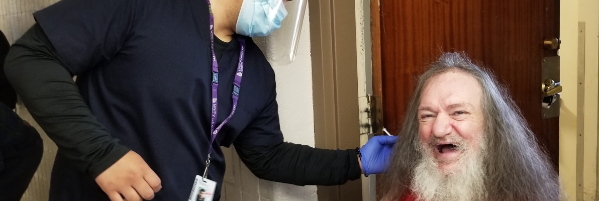 PACE client receiving vaccine